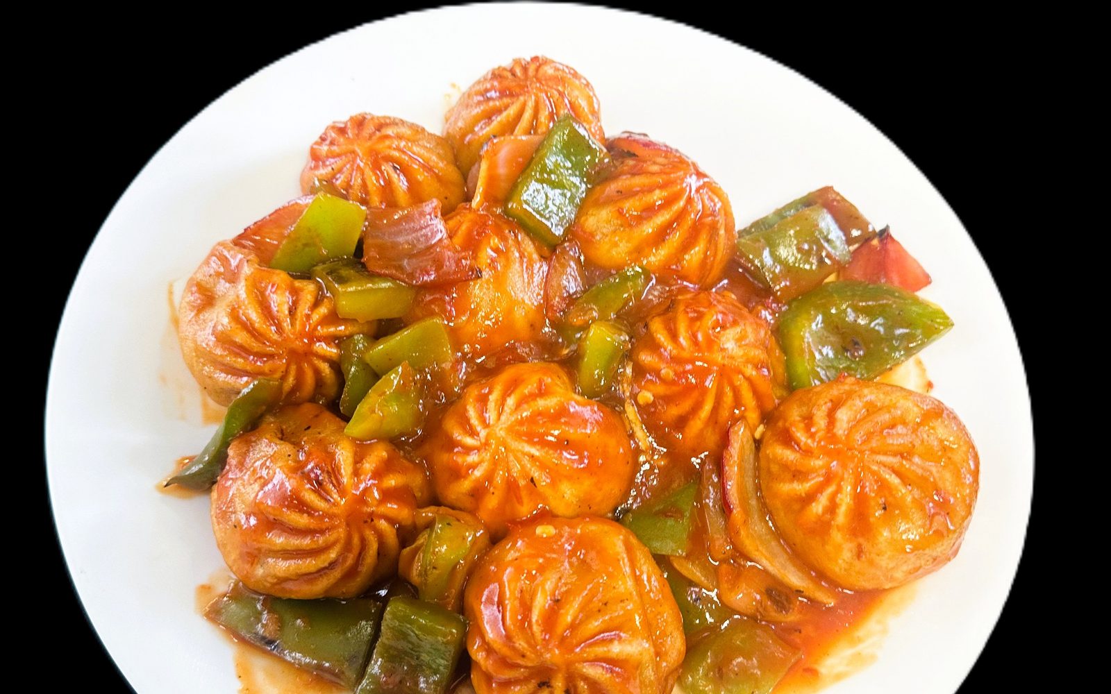 Bold colorful Chilli Mo:Mo wok-tossed in sauce